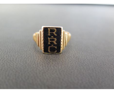 An enamel panel ring - The black enamel with the initials RRC - Tests as high carat gold - Ring size P 1/2 - Weight approx 7.