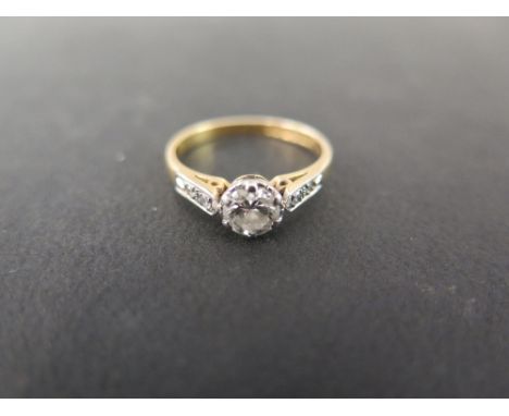 An 18ct gold diamond ring - The brilliant-cut diamond to the single-cut diamond shoulders and plain band - Estimated diamond 