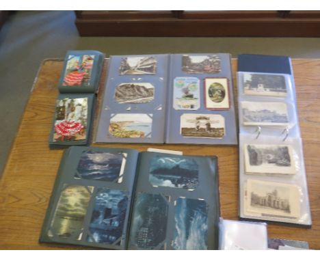 A collection of postcards including four albums containing topographical portrait, hand tinted and silkwork postcards