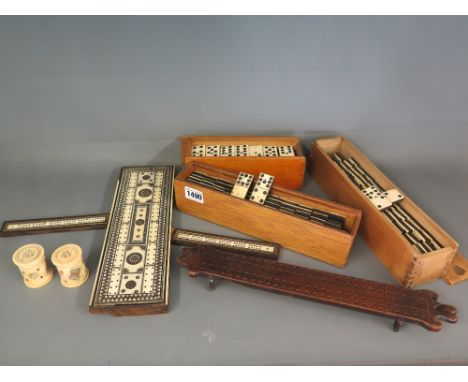 Three sets of bone and ebony dominoes, an Indian ivory and ebony inlaid cribbage board, a wooden cribbage board and two 19th 