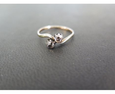 A rose-cut diamond two-stone crossover ring - Tests as 9ct gold - Ring size O 1/2 - Weight approx 1.7gms
Condition Report: Fa