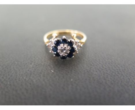 An 18ct gold sapphire and diamond cluster ring - The brilliant-cut diamond and circular-shape sapphire cluster to the similar