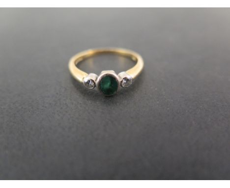 An 18ct gold emerald and diamond three-stone ring - Hallmarked London - Ring size L - Weight approx 2.5gms
Condition Report: 