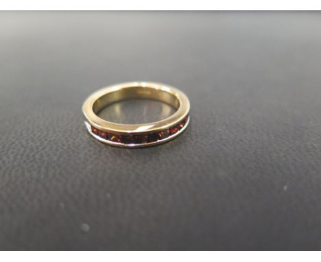 A 9ct gold diamond band ring - The square-shape red diamonds within a channel setting, to the plain band - Hallmarked Birming