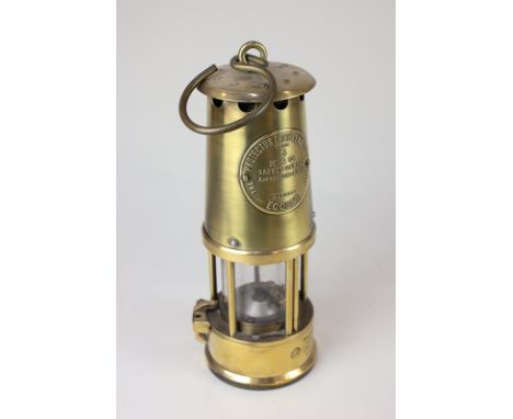A brass miner's lamp, The Protector Lamp &amp; Lighting Co Ltd Type 6, presented to Malcolm Peebles, Joined Shell 1948, 27cm