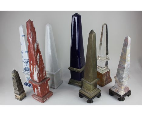 A collection of various obelisk model ornaments including hardstone, marble, and ceramic examples in blue glaze and Chinoiser