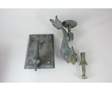 A green patinated brass door knocker in the form of a dolphin, with strike, fish 28cm long, together with another brass door 