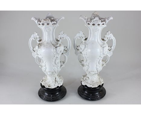 A pair of Continental porcelain white two-handled vases, each of tapered scrolling baluster form, with marks to base, each 38