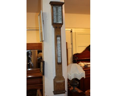 A stick thermometer / barometer in plain oak case, 99cm