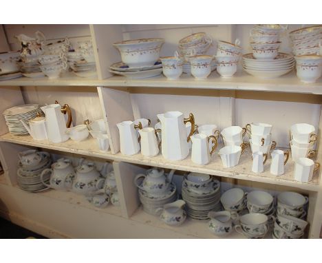 A Wedgwood porcelain part tea and coffee service in white glazed faceted form with gilt handles, to include large and small t