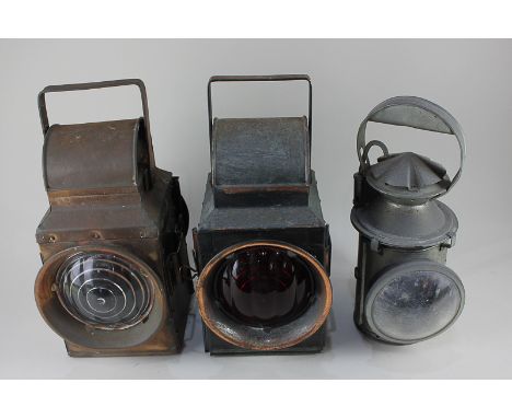 Two railway signalling lamps and another lamp