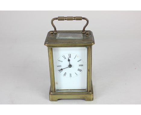 A brass and bevelled glass cased carriage clock, the enamel dial with Roman numerals, 15cm high