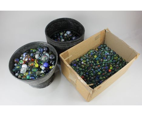 A large collection of glass marbles, various sizes and designs, together with a pewter pedestal bowl and a metal planter