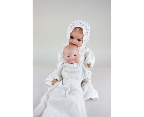 An Armand Marseille bisque head baby doll with sleeping blue eyes and closed mouth, marked AM Germany 341./2, on straw stuffe