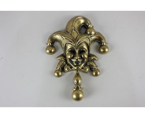 A brass door knocker formed as a laughing jester, 23cm by 17cm