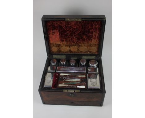 A Victorian brass bound rosewood dressing table box, fitted with silver plate mounted cut glass jars and mother of pearl hand