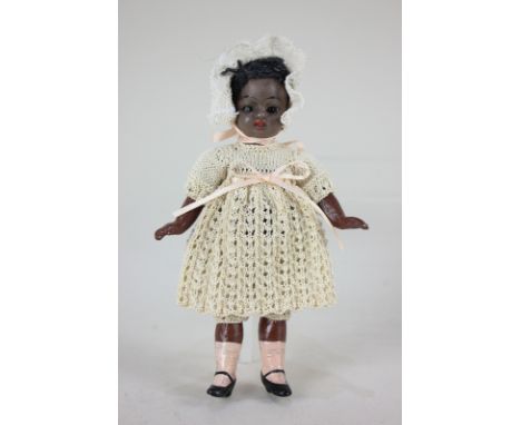 A black bisque head doll, with sleeping brown eyes and open mouth, marked 2/0, on jointed composite body with painted socks a