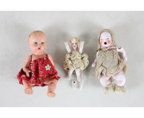 A German all-bisque doll's house baby doll with painted blue eyes and open mouth, on jointed body, dressed in bonnet, dress a