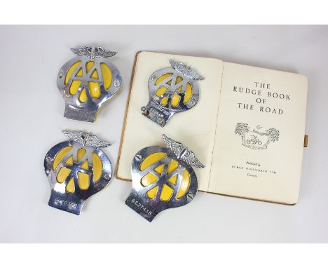 A collection of four Automobile Association badges including one smaller for a motorcycle, together with The Rudge Book of th