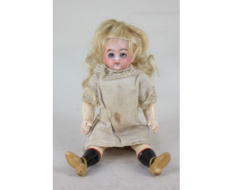 A bisque head doll, with sleeping blue eyes, open mouth and blonde wig, marked 39, on jointed composite body with painted soc