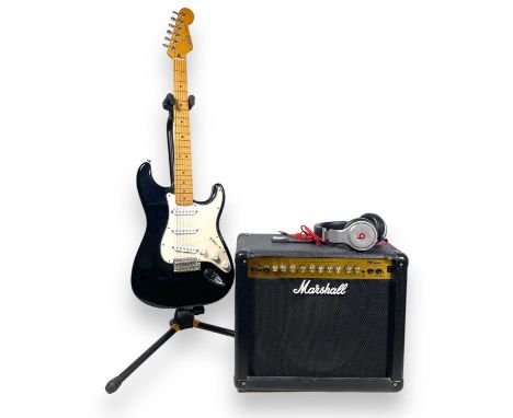 A black Mexican Fender Stratocaster, serial no: MZ4135995. Also included is a Marshall MG30DFX amplifier, a guitar stand, a g