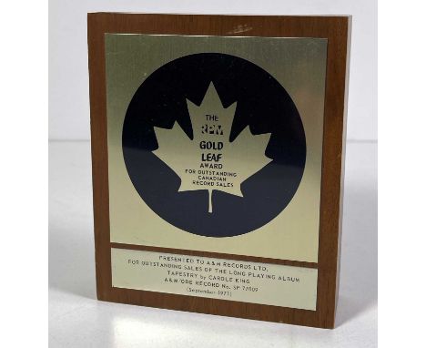 A presentation plaque (on a wooden block, approx 12.5x15x3cm) given to A&amp;M Records to recognise 'Outstanding Canadian Sal