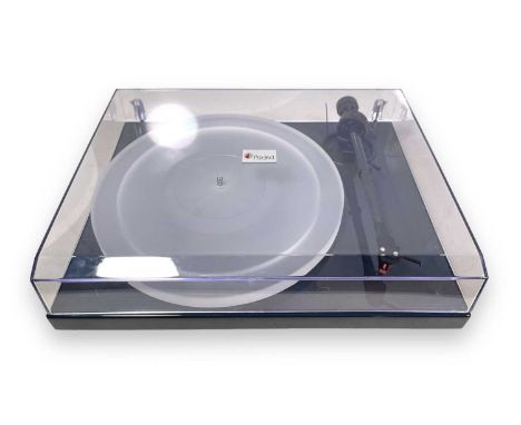 A Pro-Ject 1-Xpression III turntable in black with a Pro-Ject carbon tonearm, clear acrylic platter, an Ortofon 2m red stylus