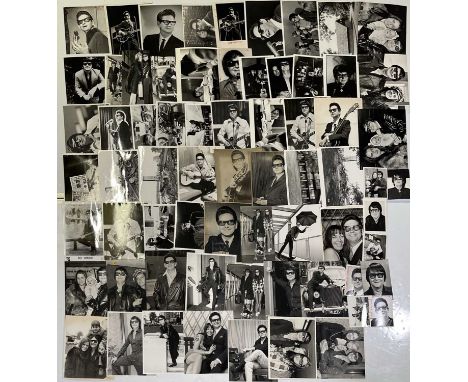 60 variously sized (many c 8x10") black and white press photographs depicting Roy Orbison, many vintage prints with press sta