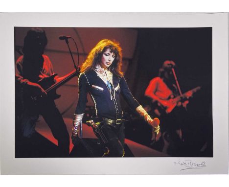 A high-quality full-colour print on thick paper stock of an image depicting Kate Bush onstage in 1979. Measures 42x29.5cm. Si