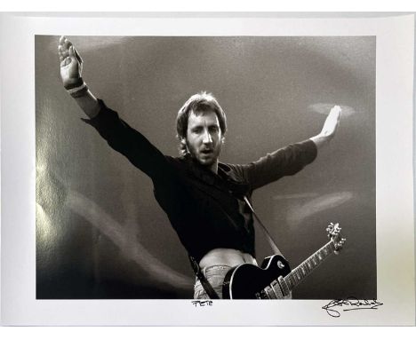 A high-quality photo print of a photograph by John Rowlands depicting Pete Townshend onstage. Signed and titled by the photog