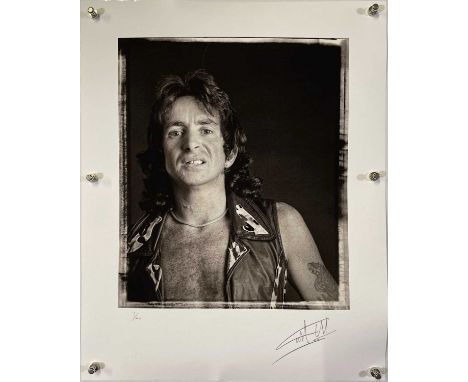 A high-quality archival print of images by Martyn Goddard depicting AC/DC frontman Bon Scott in his first UK press photo shoo