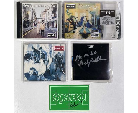 Two Oasis CDs each signed by Noel Gallagher, a promo DVD signed by Andy Bell, a sticker and a CD single signed by Tony McCarr