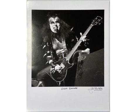 A high-quality photo print of a photograph by John Rowlands depicting Gene Simmons onstage with Kiss. Signed and titled by th