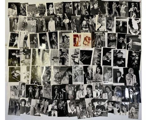 114 variously sized (many c 8x10") black and white press photographs depicting Rod Stewart, many vintage prints with press st