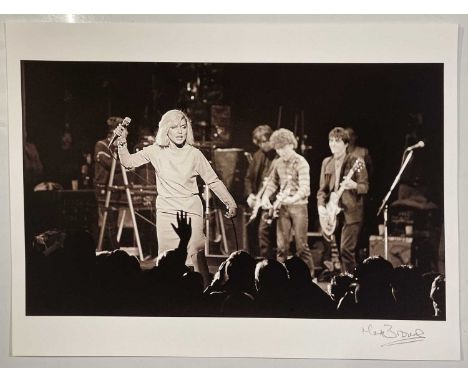 A high-quality print on thick paper stock of an image depicting Debbie Harry and Blondie onstage at the Hammersmith Odeon dur