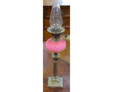 A Victorian oil lamp, writhen pink reservoir, plated Corinthian column.