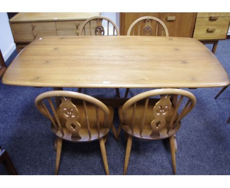 An Ercol trestle type dining table; a set of four conforming dining chairs (5)