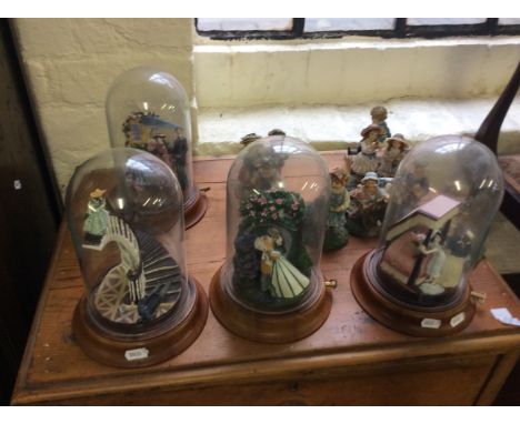 A quantity of 'Leonardo Collection' ceramic figurines to include some with bell jar decoration.