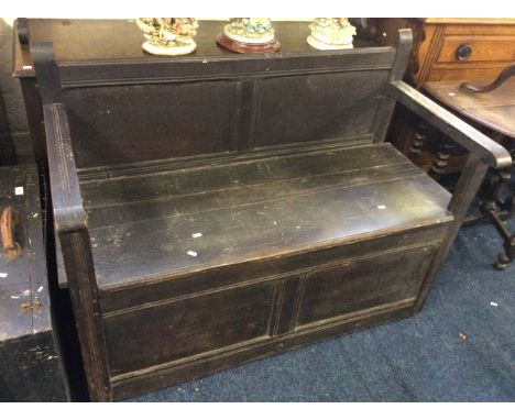 A stained oak monks bench.