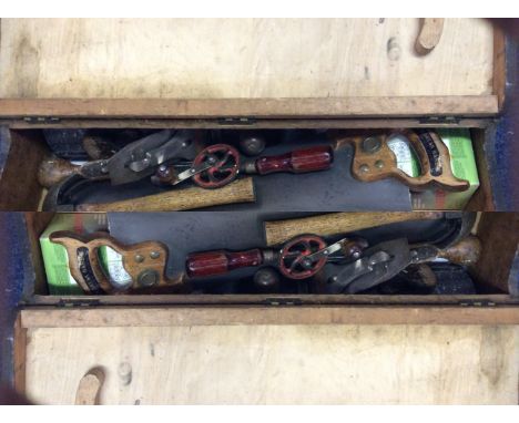 A wooden tool box containing a selection of carpenters tools.