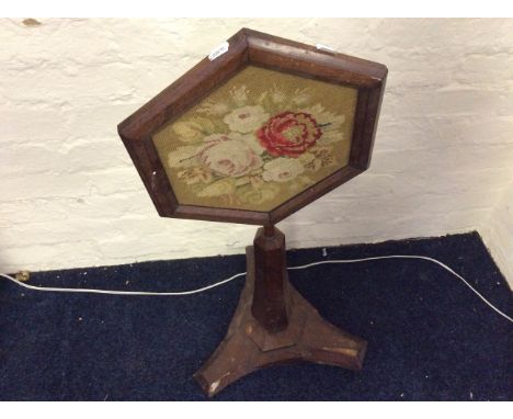 A mahogany embroidered floral fire screen together with an oak single column table.