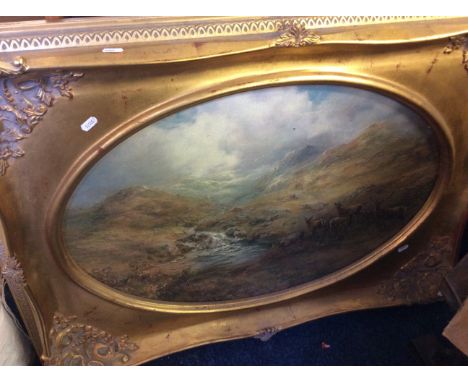 A gilt framed print of a mountainous landscape with deers in foreground.
