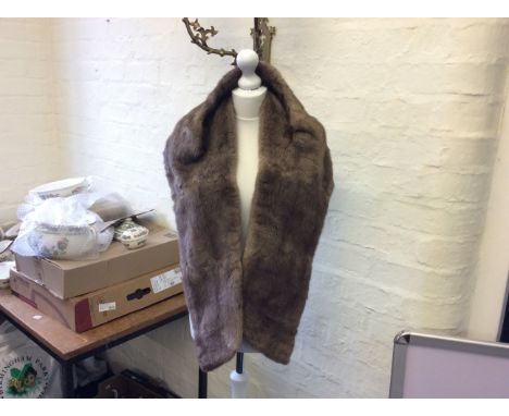 A light brown mink shawl.