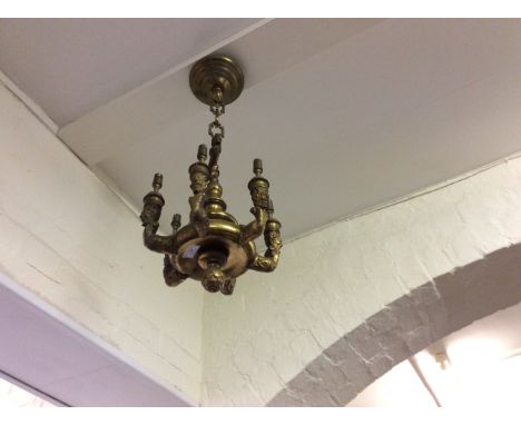 Six branch brass light fitting with head figure decoration