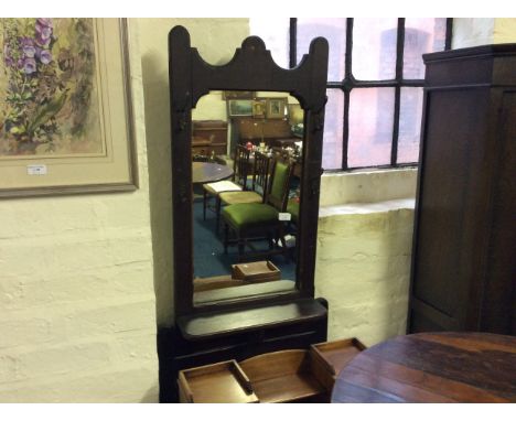 A mahogany coat stand with mirrored back and umbrella stand base.