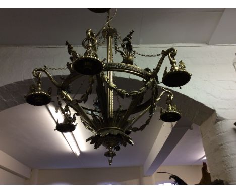 A six branch brass light fitting with swag decoration