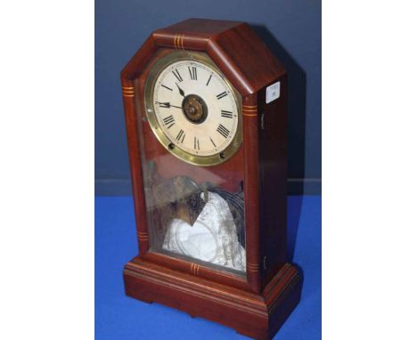 MAHOGANY MANTEL CLOCK
of irregular rectangular form, with fial with ROman numerals, the glass front of the case with Neoclass