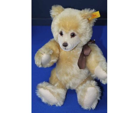 STEIFF STUFFED BEAR
with brown ribbon and yellow ear label named 'Knopf Im Ohr' and numbered '010354', 27cm high
