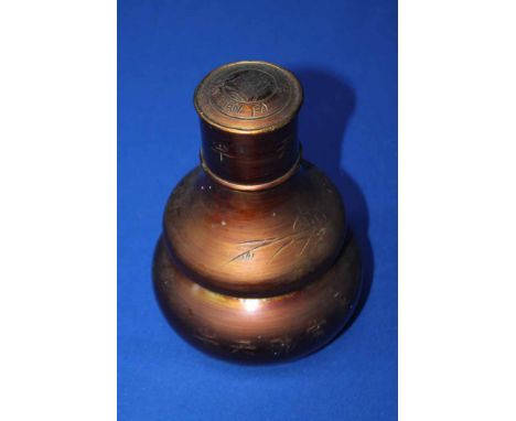 20TH CENTURY CHINESE TEA CADDY
of double gourd form, the coppered metal with incised characters, 20.5cm high