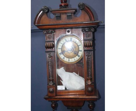 VICTORIAN MAHOGANY WALL CLOCK
with carved pediment, the gilded dial with enamel chapter ring with Roman numerals, with pendul